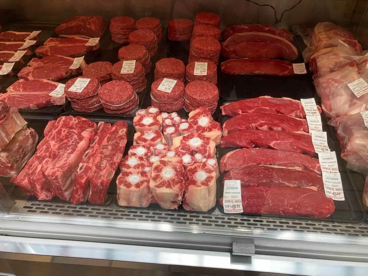 butchers case with ground beef, ribs, and other red meat