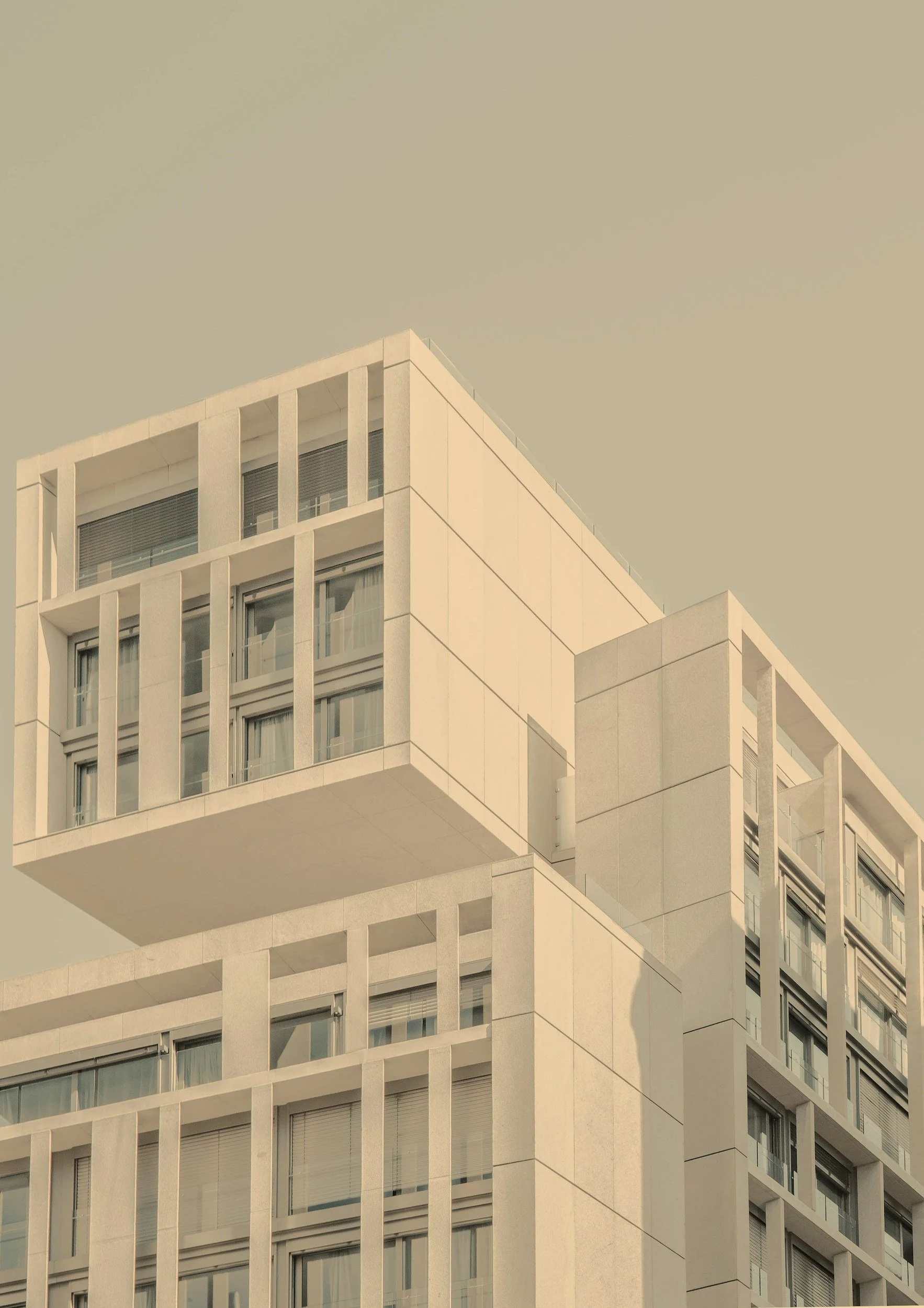 Modern white building with geometric architecture and large windows