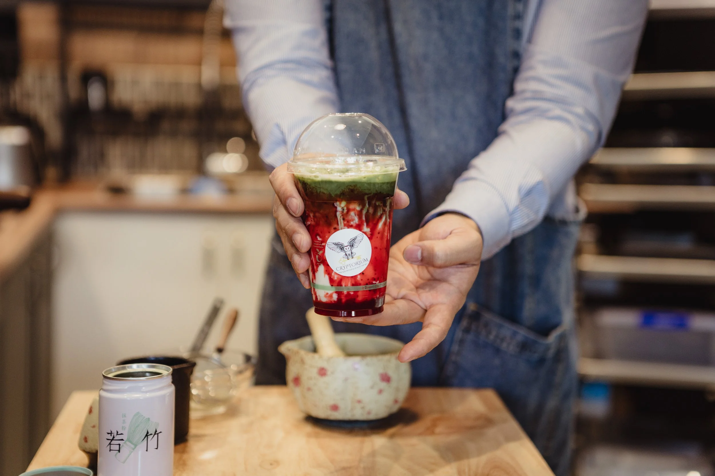 a man is holding a strawberry matcha