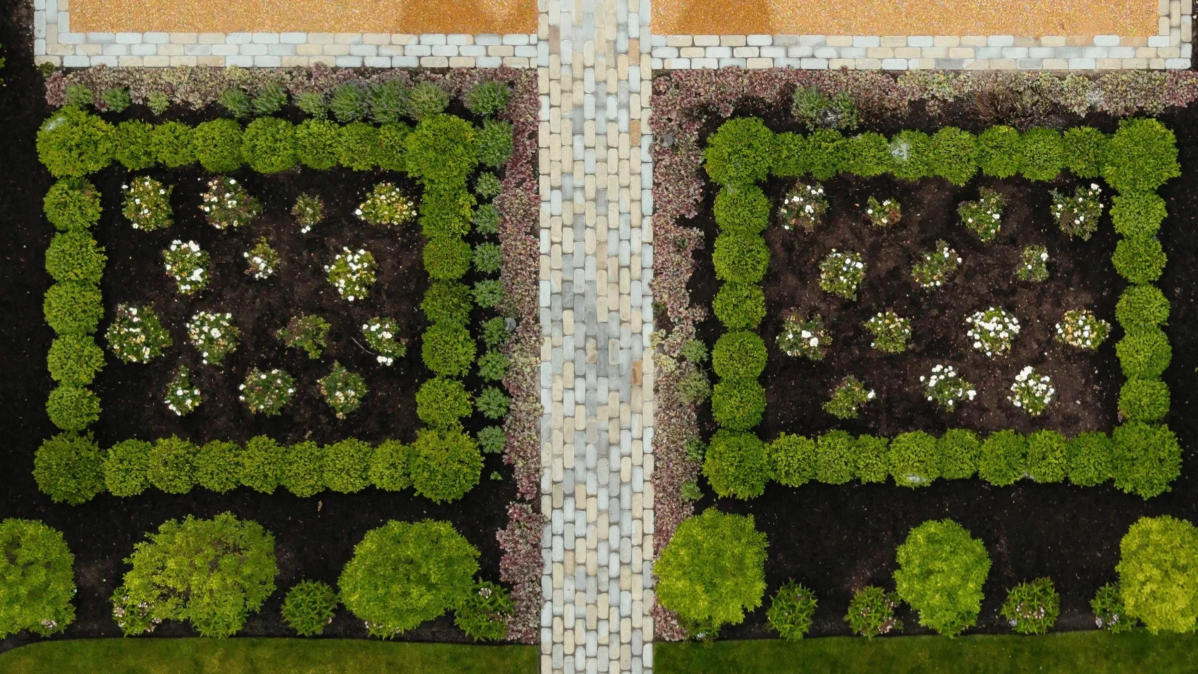 landscaping-aerial-boxwood-parterre-garden-cobblestone-walkway-pappas-company-landscape.webp