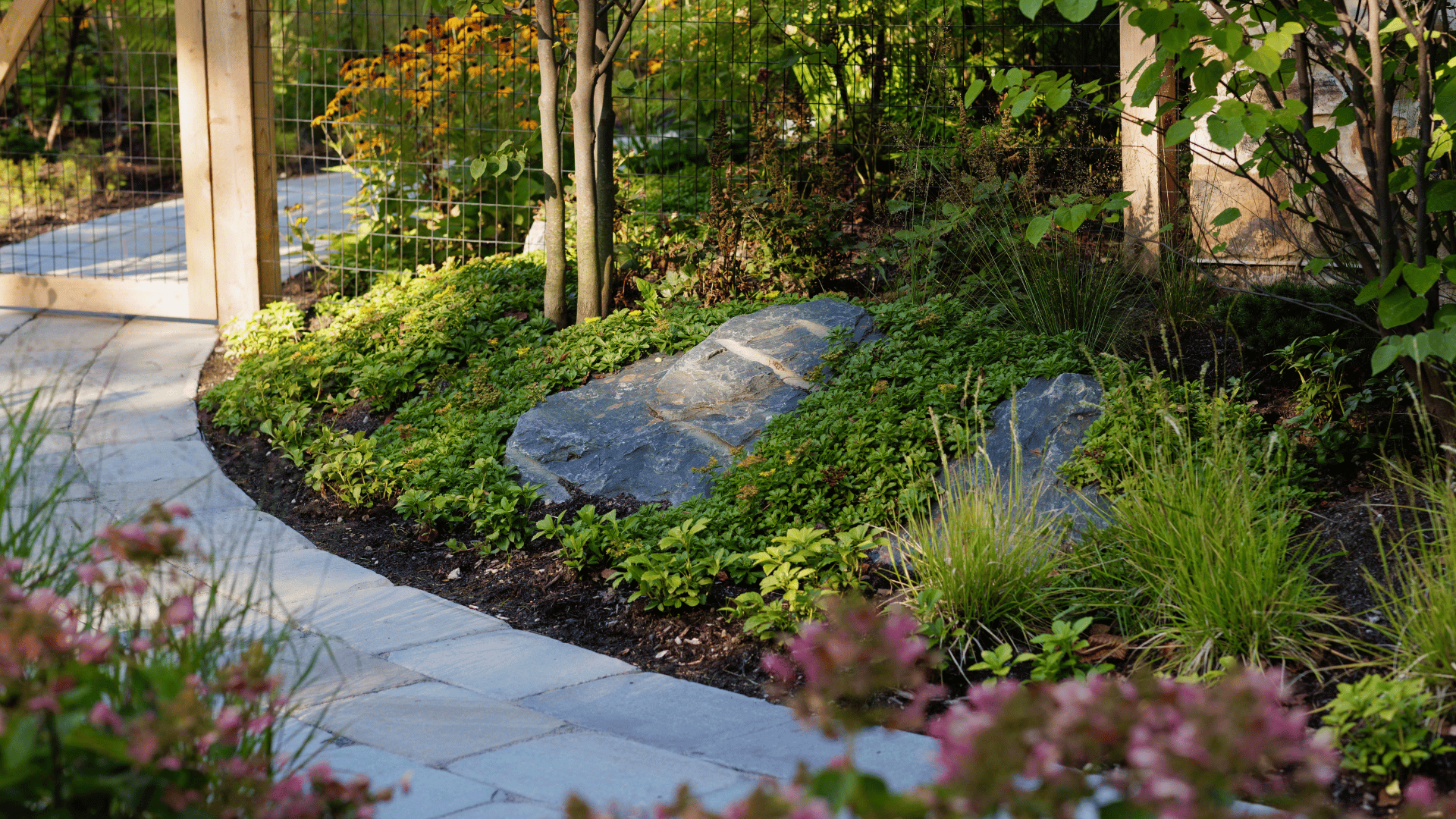 Riverwoods IL Boulder Accent Planting Bed Along Stone Pathway Near Gate pappas company construction landscape design landscaping