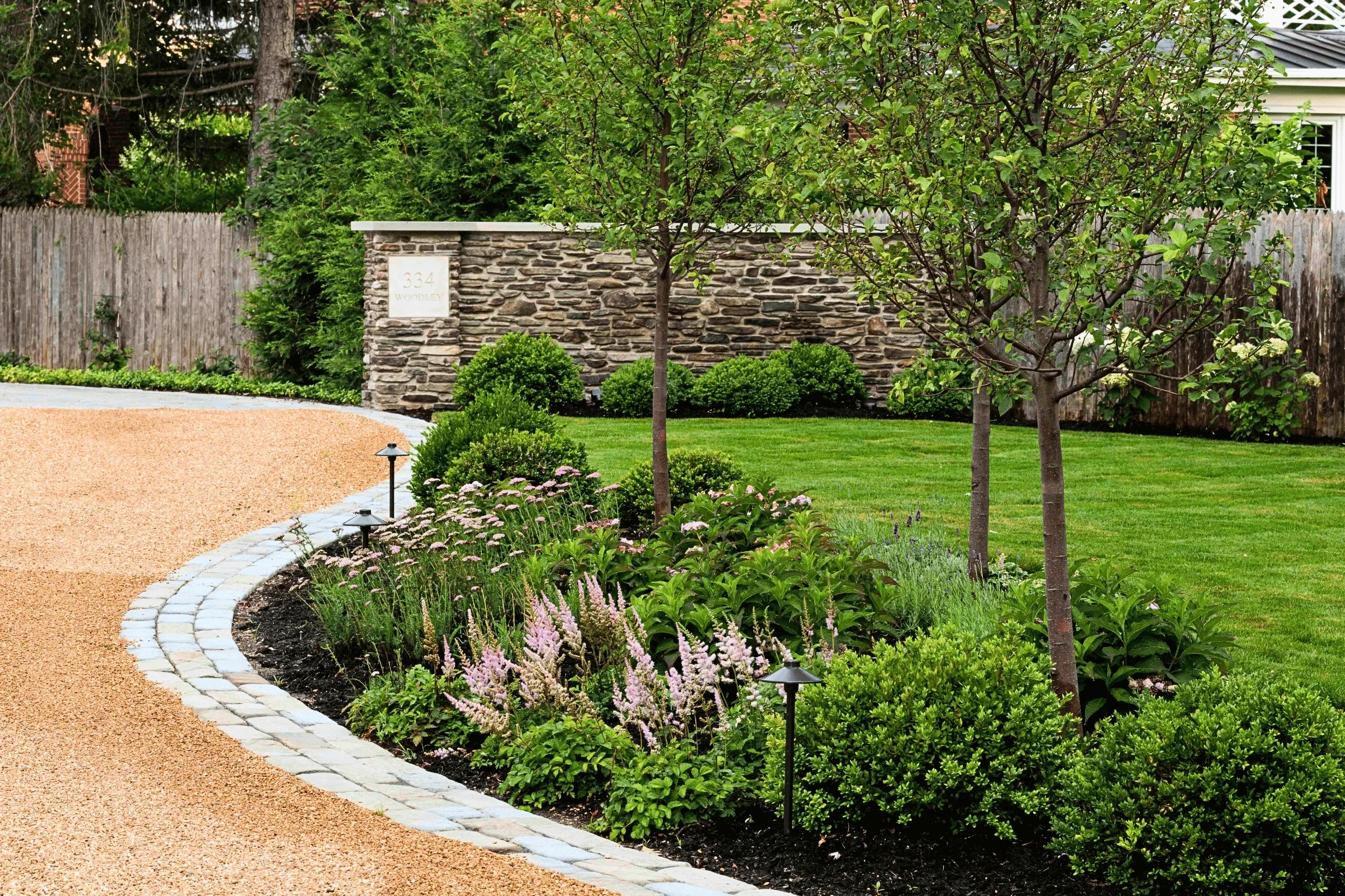 landscaping-perennial-garden-bed-curved-driveway-cobblestone-border-pappas-company-landscape.webp