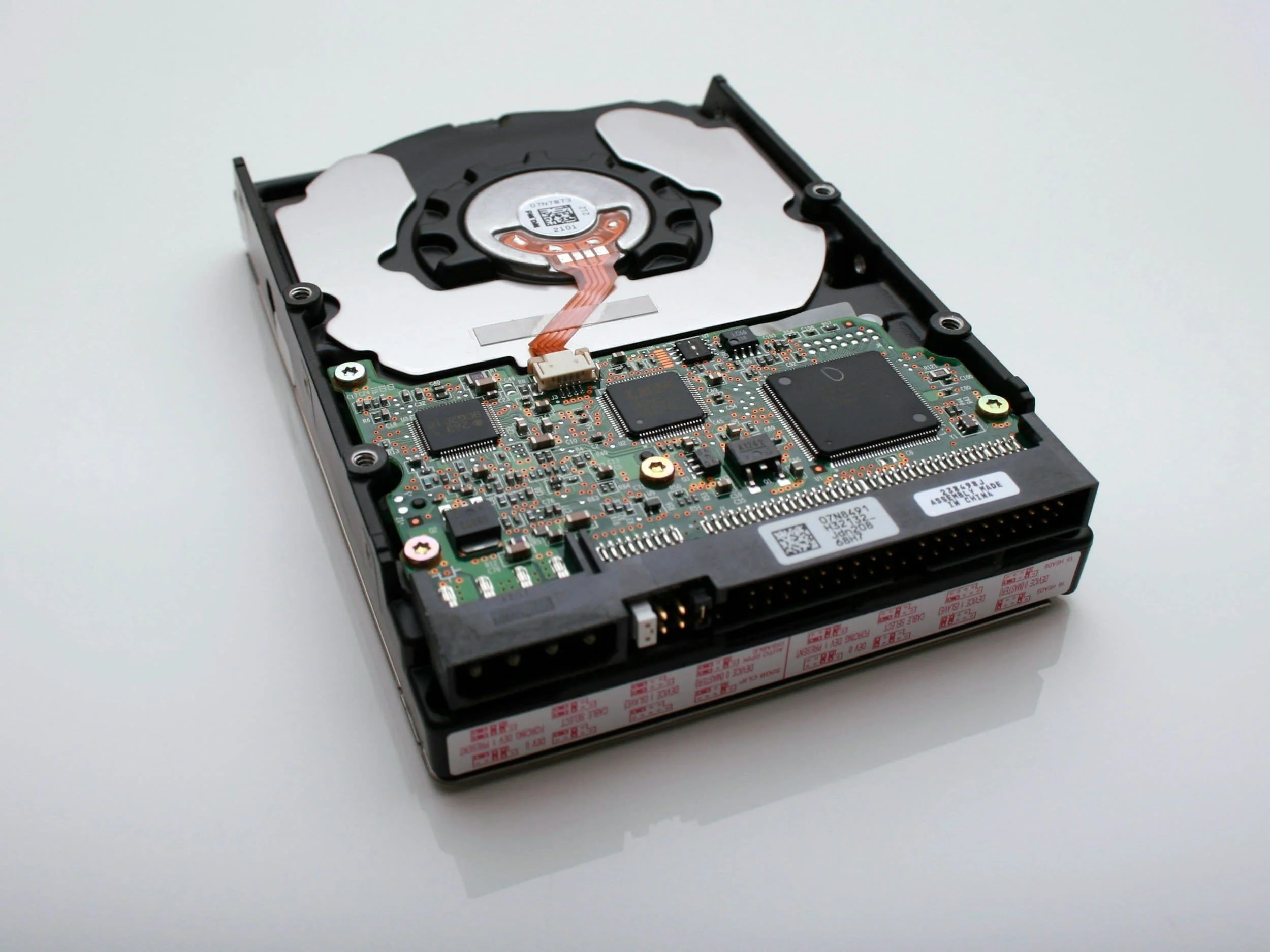Hard drive sitting on a white background ready for hard drive destruction