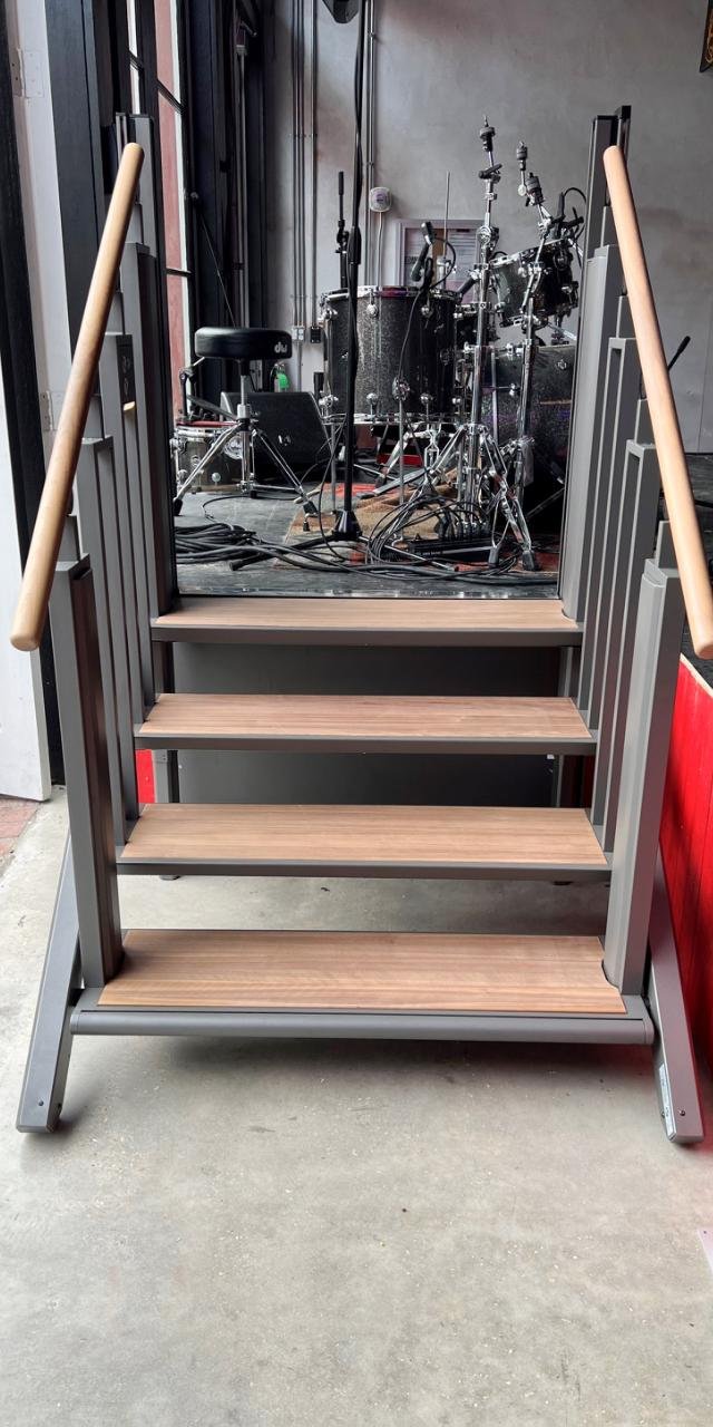 Staircase leading to a music practice room with drums visible inside.
