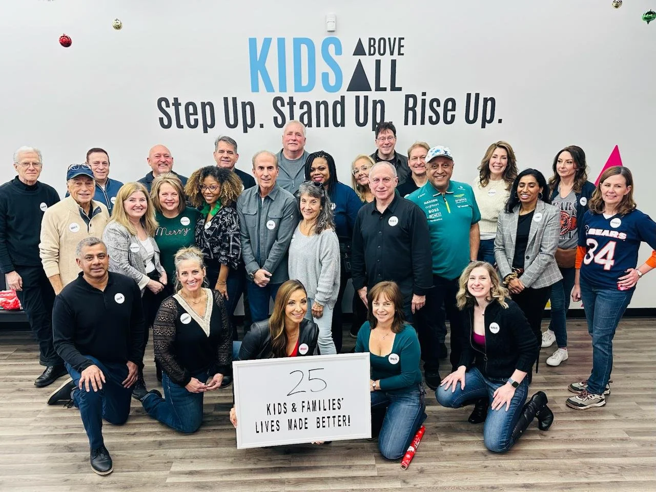 Group photo of Megan Wessels with a group of Throwback Daters at the Singles In Service event at Kids Above All, where they wrapped gifts for kids in need.