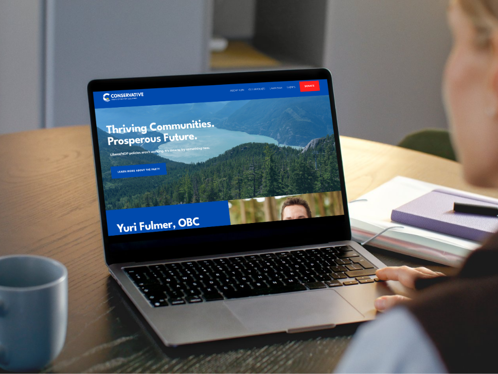 Person browsing a website on a laptop with a nature landscape and political message about thriving communities.