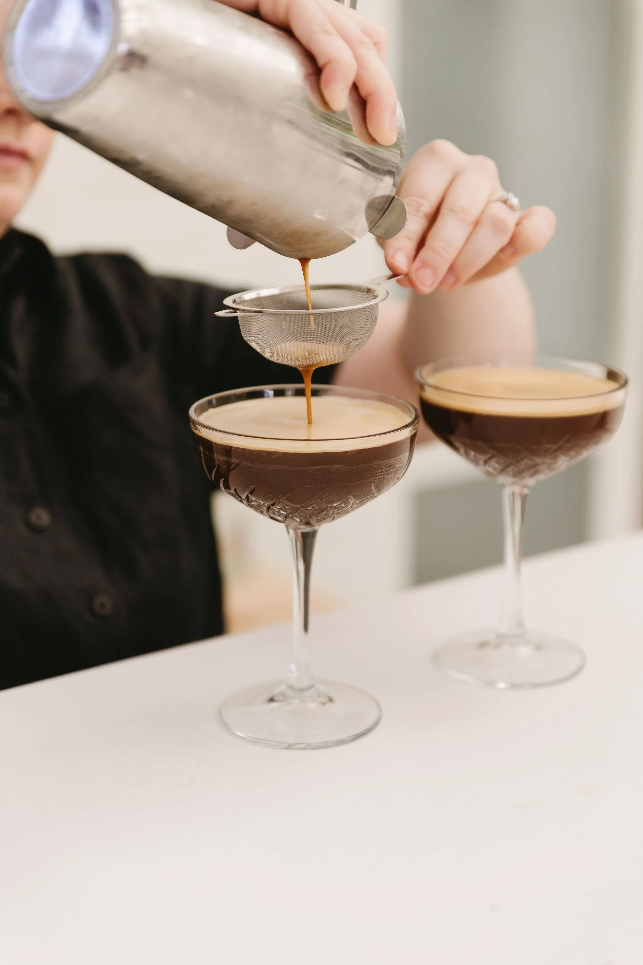 Friendly staff pour two espresso martinis for guests at Sublime Social.