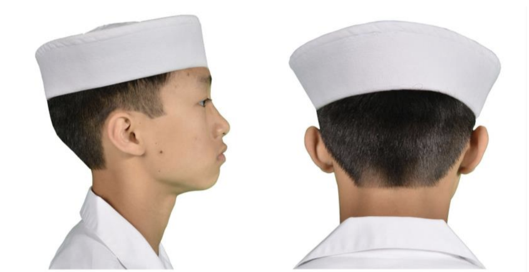Side and back view of a young boy wearing a white nurse's cap and a white coat.