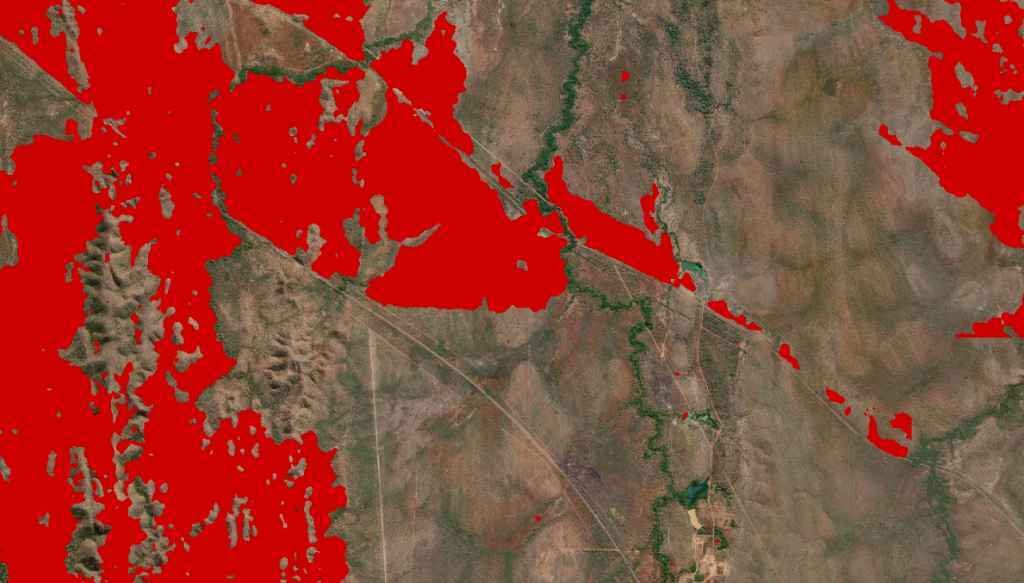A bushfire burn scar highlighted in a solid red layer as detected by FiSci’s deep learning algorithm, overlaid across high-resolution aerial satellite imagery.