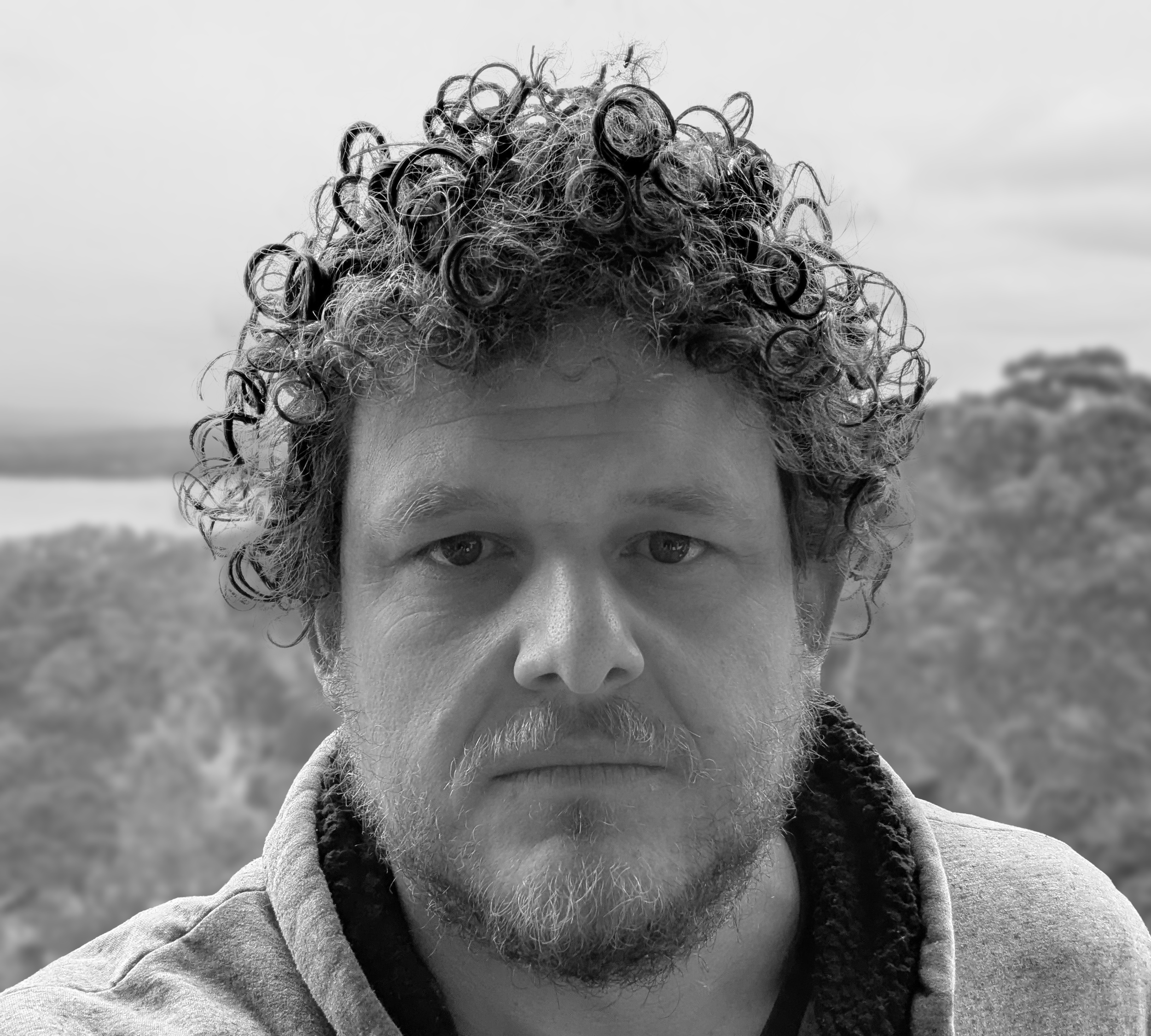 A black and white portrait of Matthew Robards, a founder of the AI-driven bushfire management company FiSci
