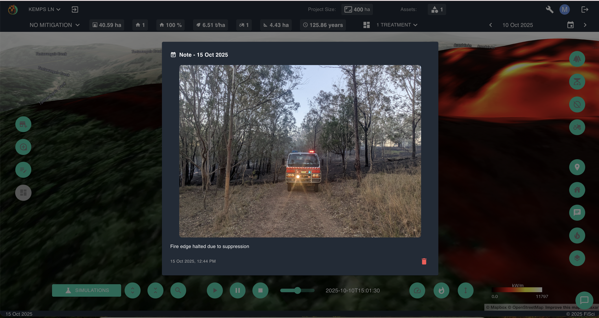 A field photograph logged within the FiSci Mitigate platform dashboard displaying a fire truck appliance stationed on a bush track next to a contained fire edge, demonstrating real-world operational suppression verification.