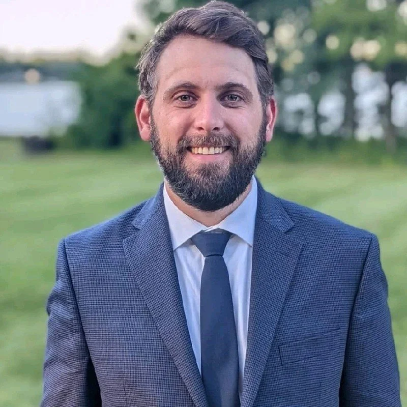 A color portrait of Gregory Vigneaux, a US-based Technical Account Executive of the AI-driven wildfire management company FiSci