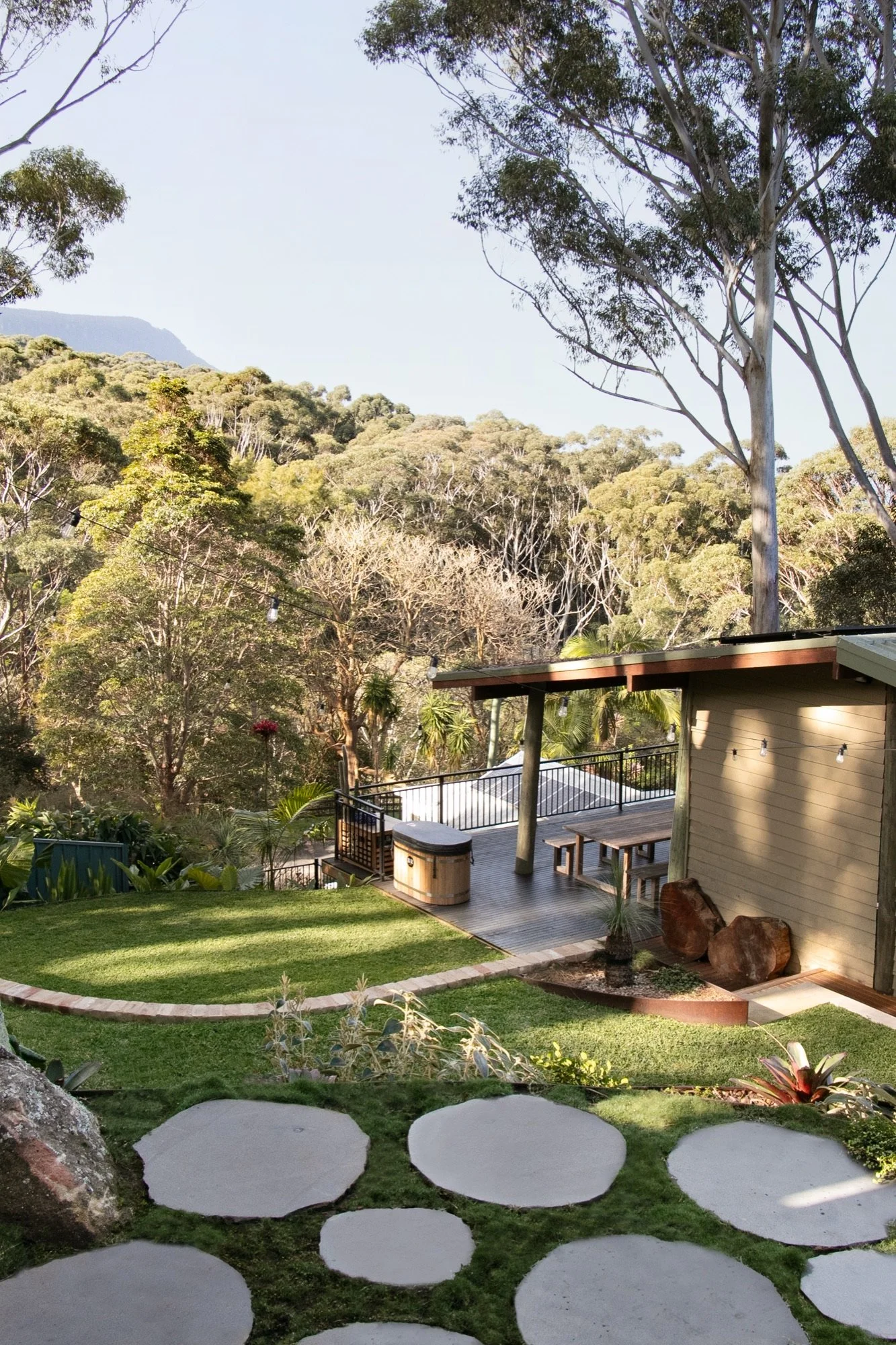 Terraced lawn with sandstone stepping stones looking toward the Illawarra escarpment in Bulli