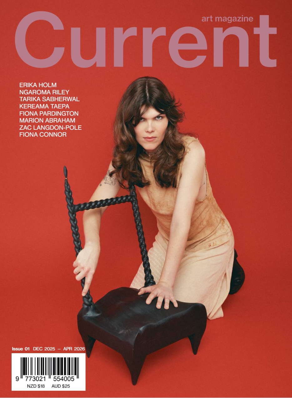 Cover of art magazine Current featuring a woman with brown wavy hair kneeling on the floor, holding a black, twisted rope object that looks like a chair against a red background.
