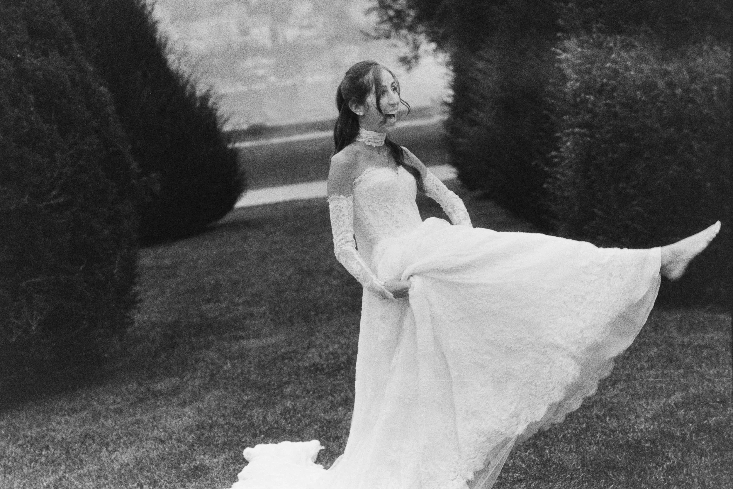 Barefoot bride lifting her dress and laughing during a candid after-wedding photo session in Italy.