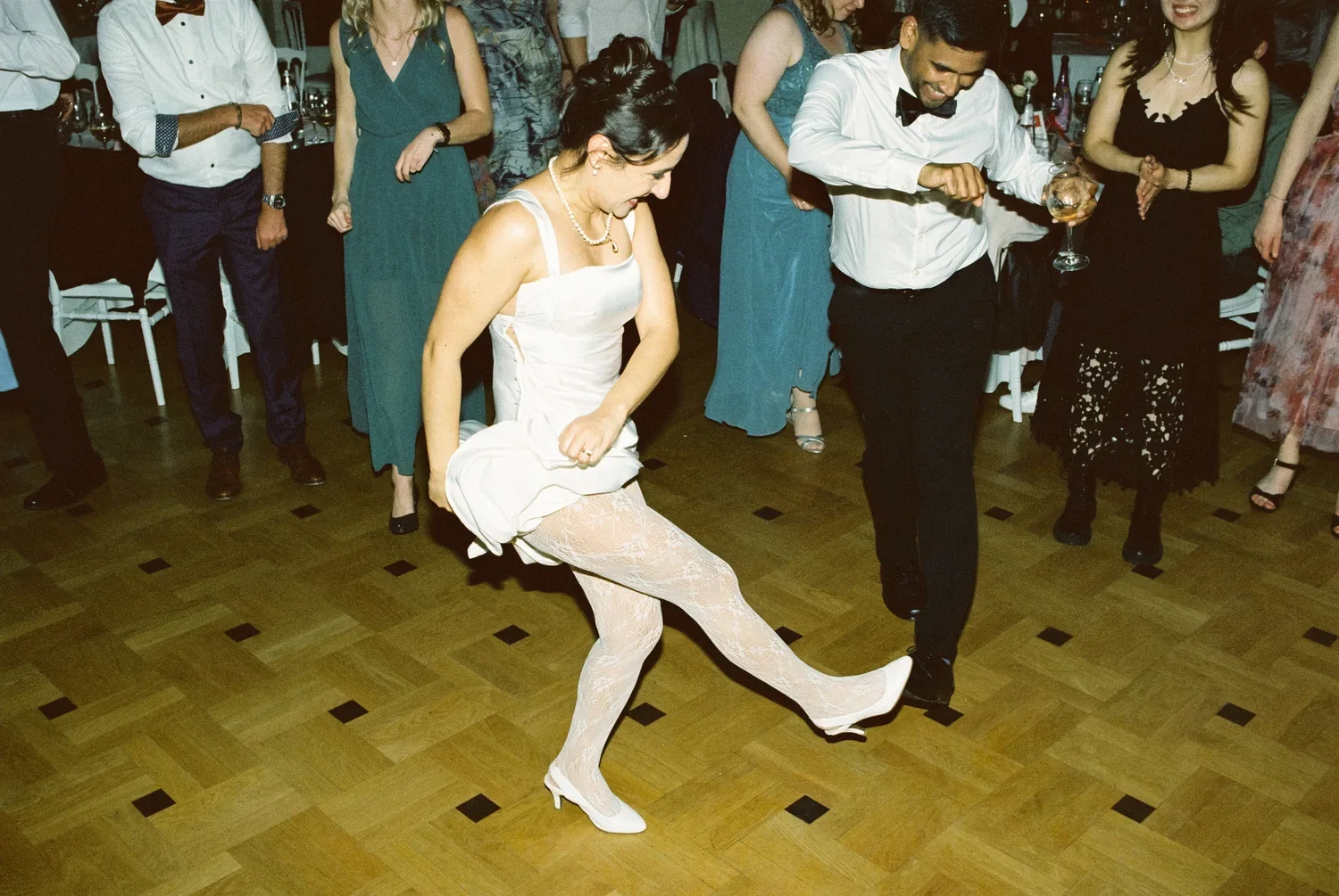 35mm-film.jpg	A dynamic close-up of Munira lost in the music, showcasing the authentic energy of the wedding night.