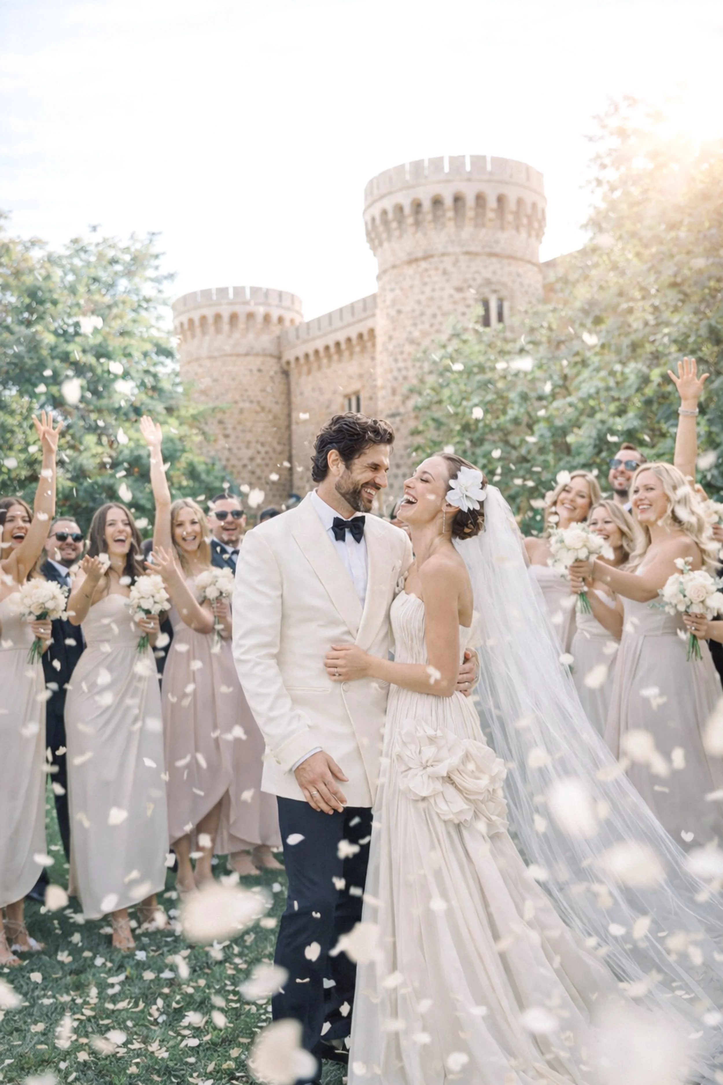 Couple celebrating their destination wedding in a historic European venue surrounded by guests