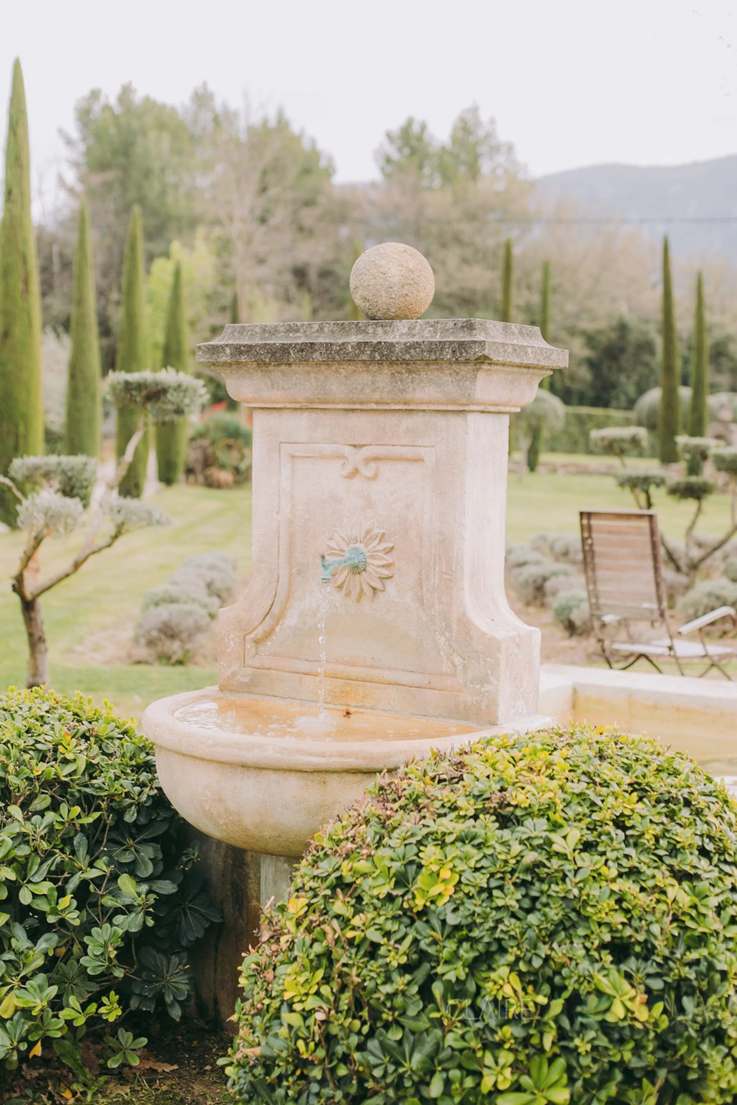 Luxury destination wedding ceremony in Europe with floral arrangements and breathtaking countryside views.
