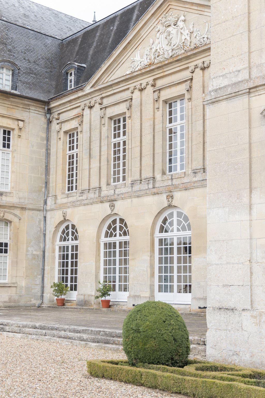 Elegant European wedding venue prepared for an outdoor ceremony at sunset.