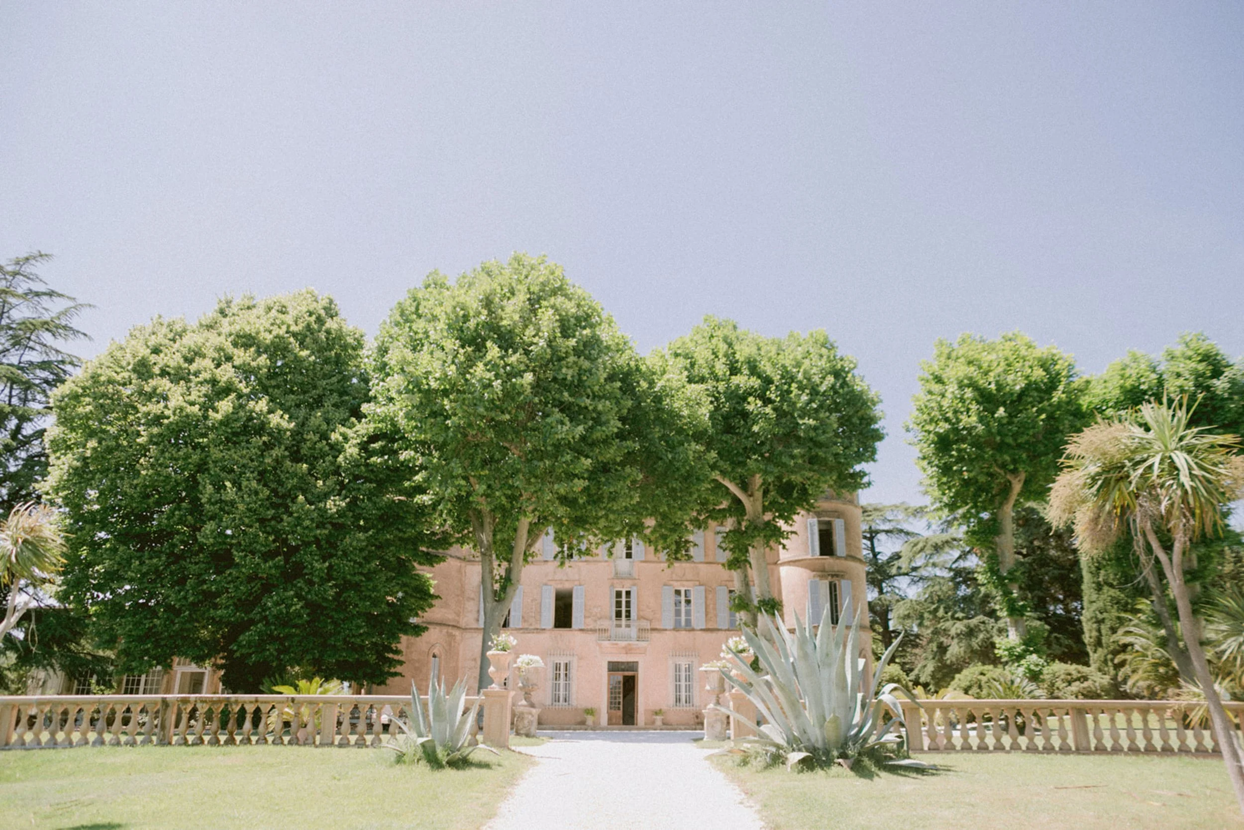 Elegant European wedding venue prepared for an outdoor ceremony at sunset.