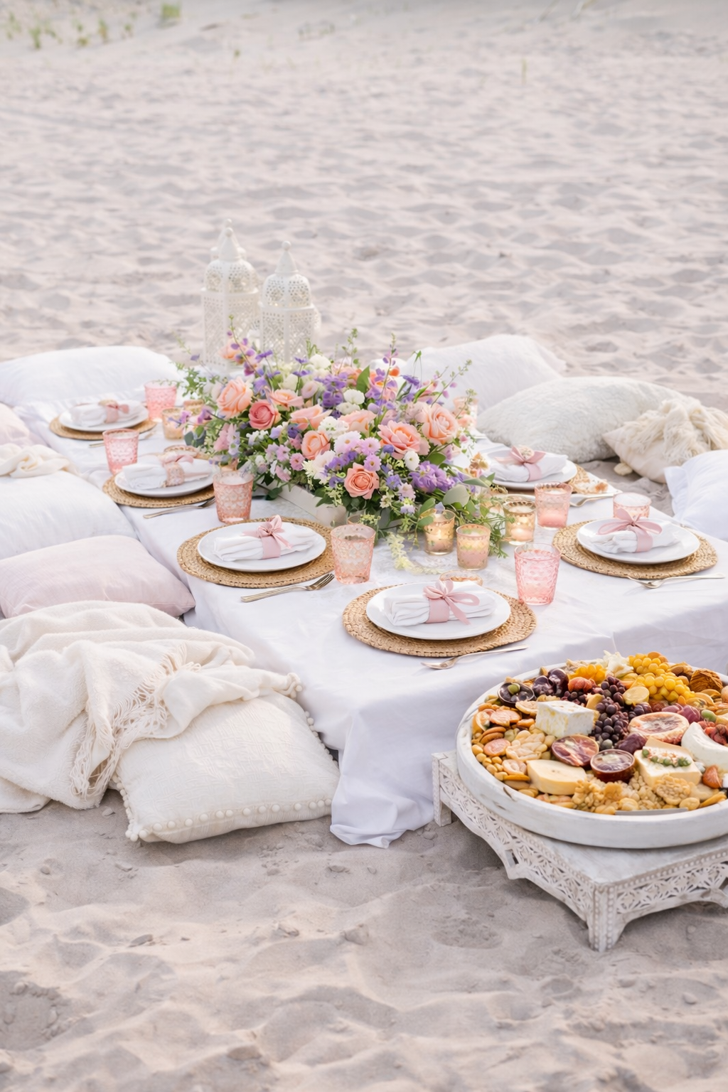 Refined luxury beach picnic for a European destination bachelorette party with feet in the sand