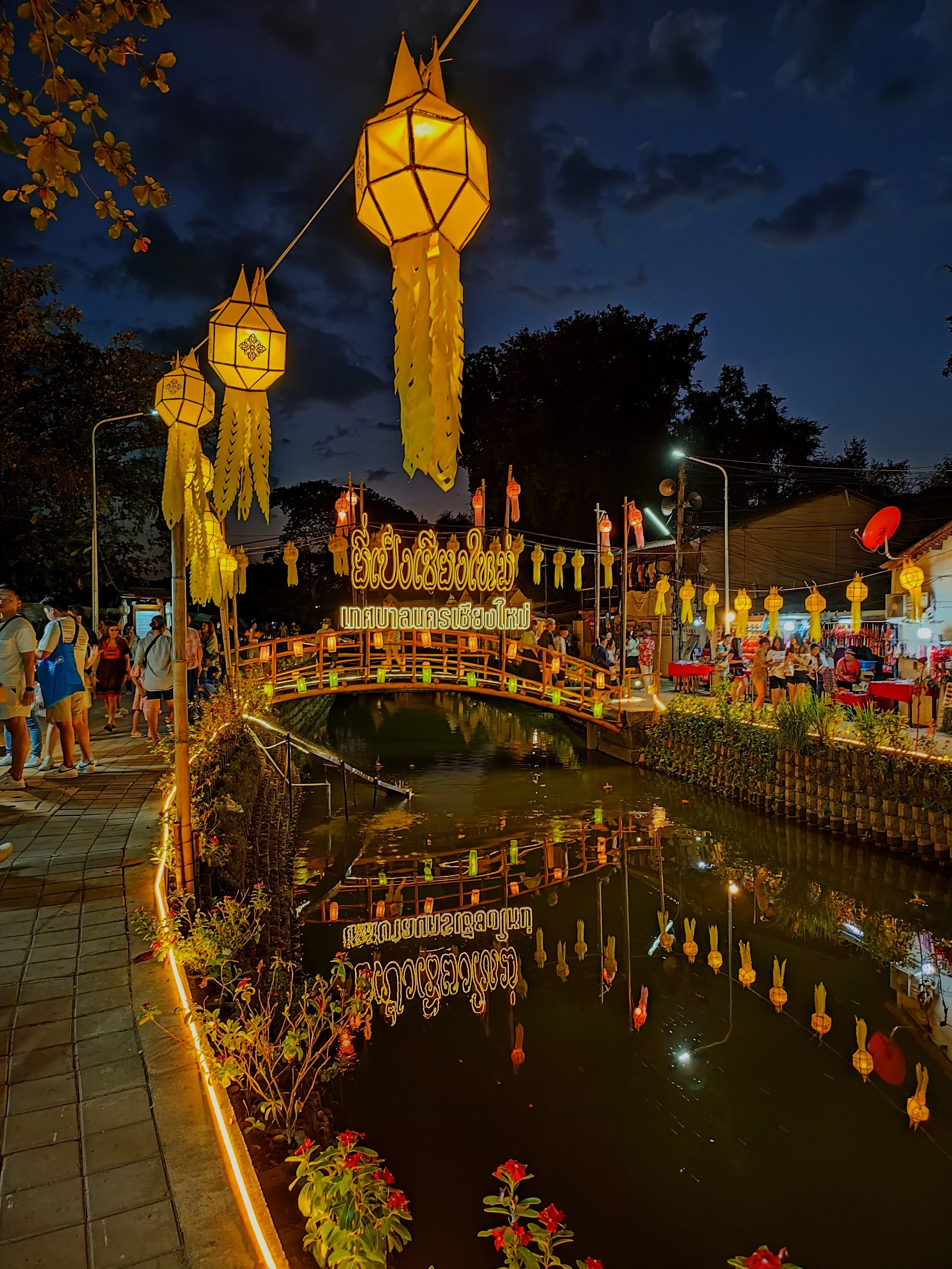 loy krathong water festival in the river with lanterns and reflections