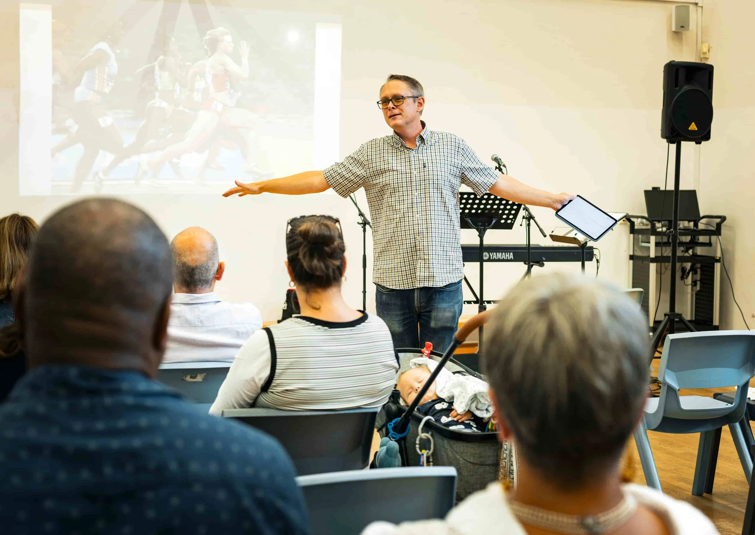 man preaching at church, with people listening