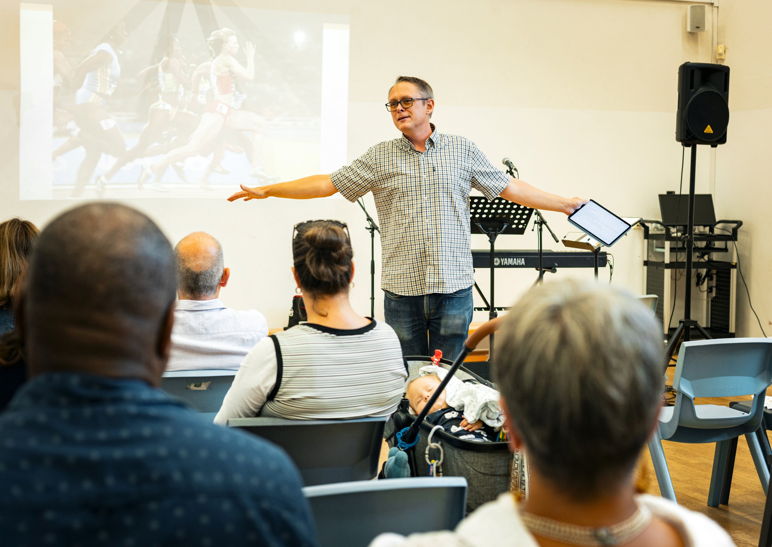 a person preaching with a bible open on a lectern with a phone