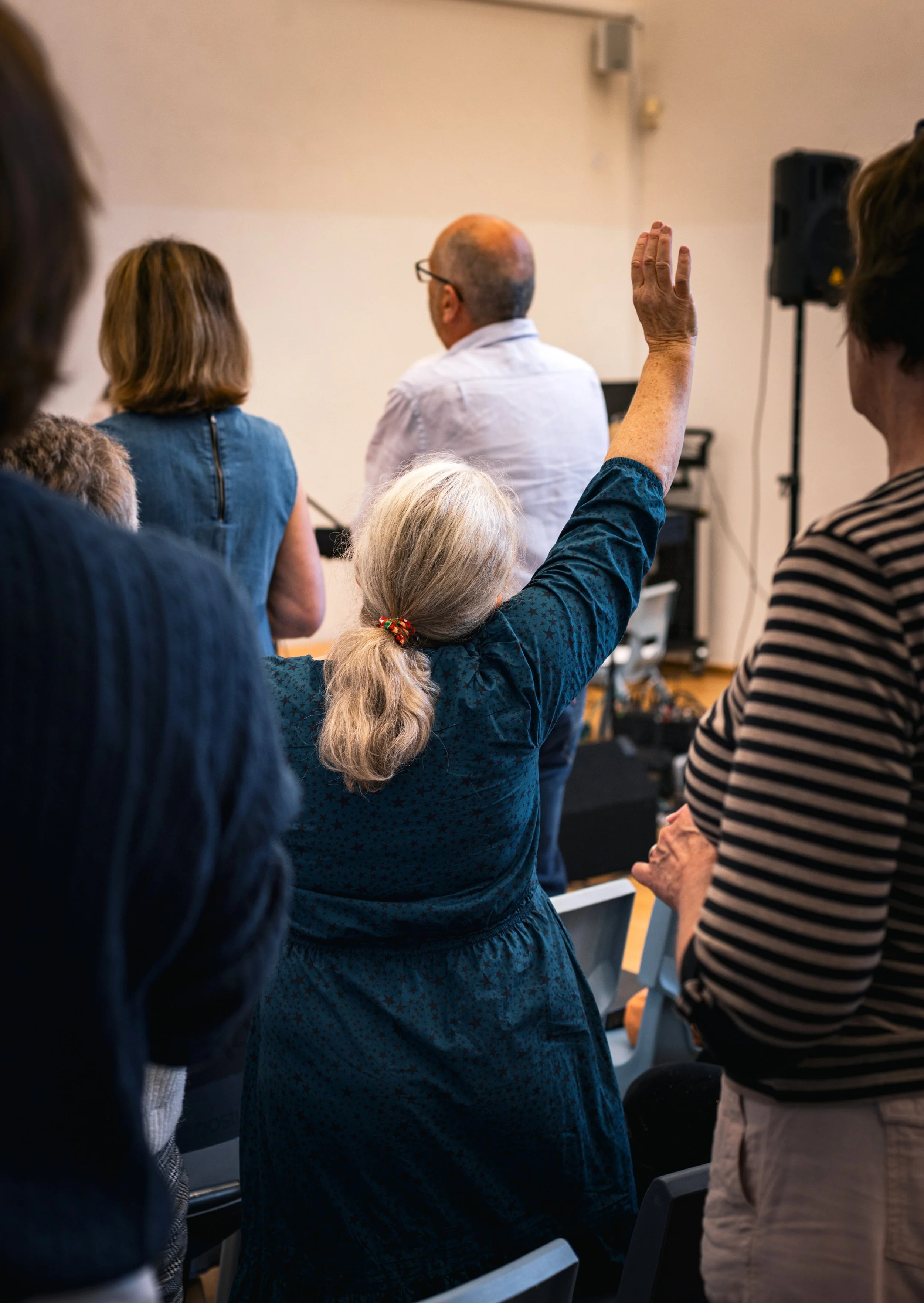 a woman with an arm raised in prayer