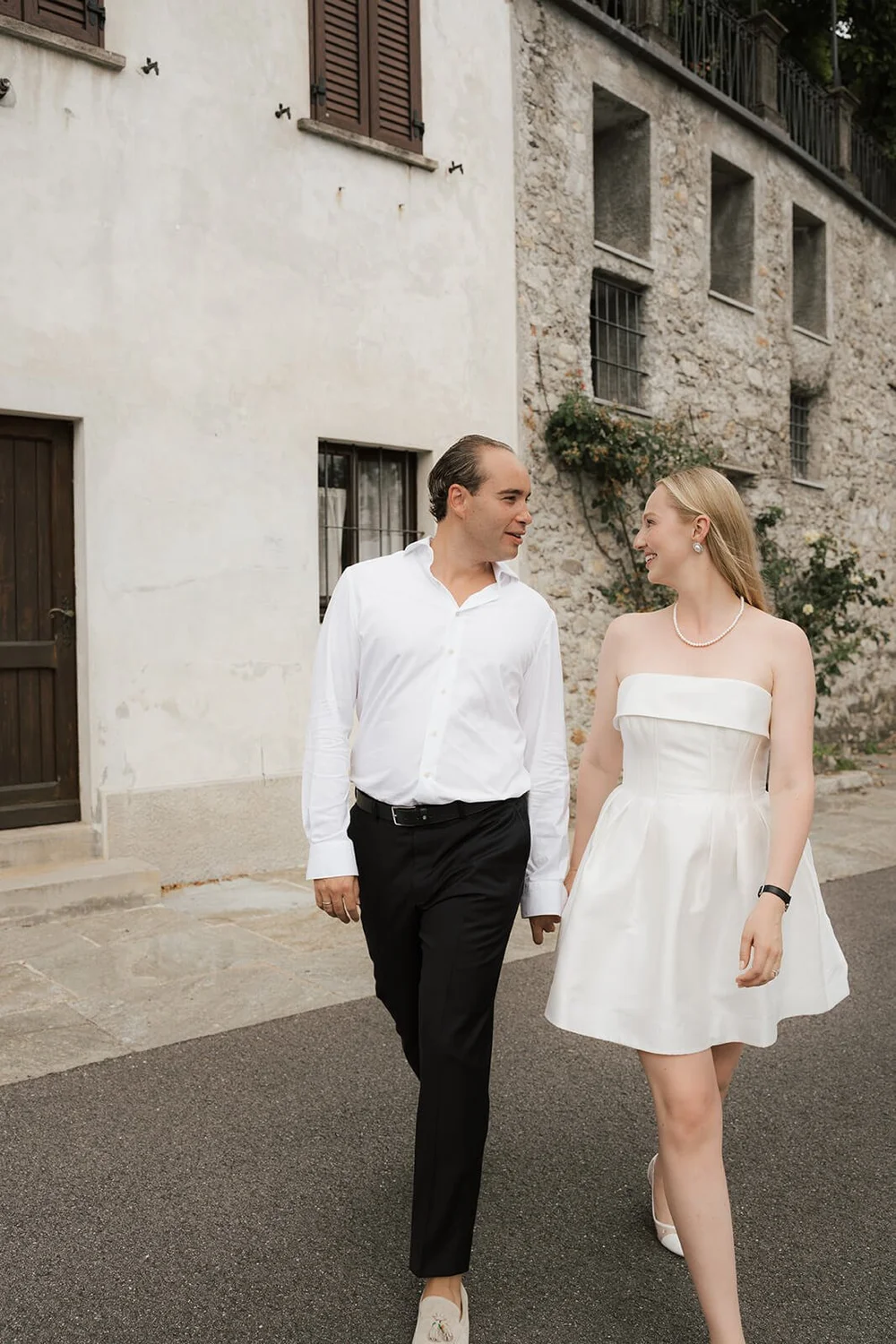 Zoe and Niklas walking through a lakeside village
