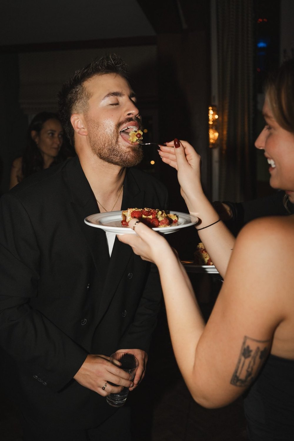 Guests sharing cake at the late-night party