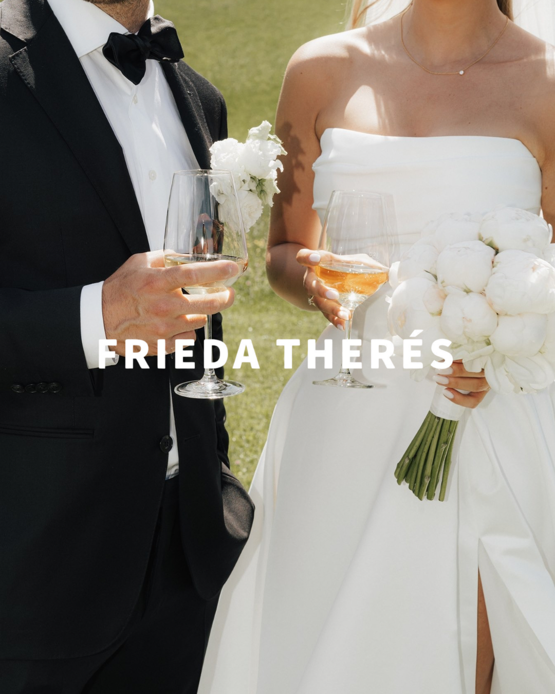 Close-up of a newlywed couple holding glasses of champagne at their wedding outdoors, with the bride holding a bouquet of white peonies.