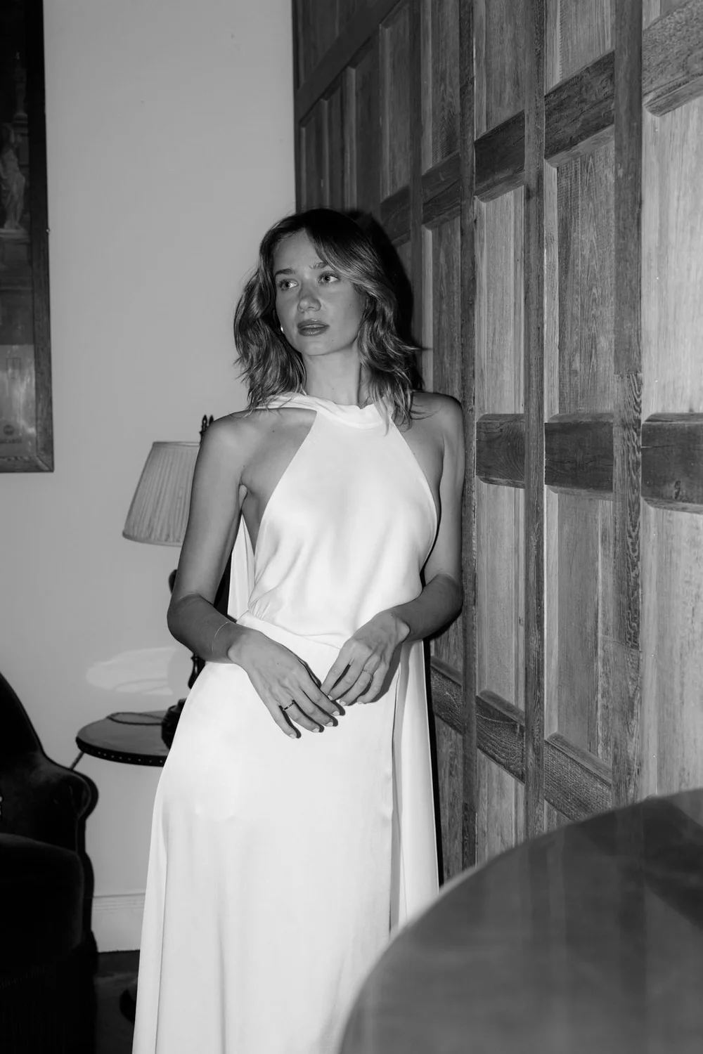 Bride leaning against wood panelling at Soho House Berlin, black and white