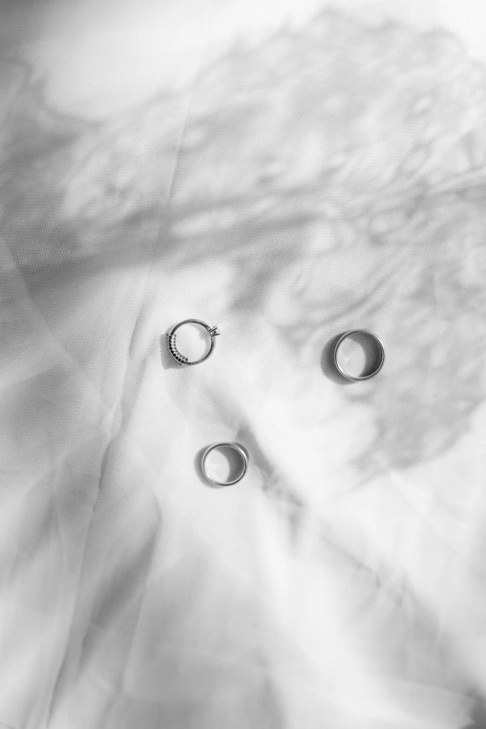 Wedding rings on a white sheet, black and white