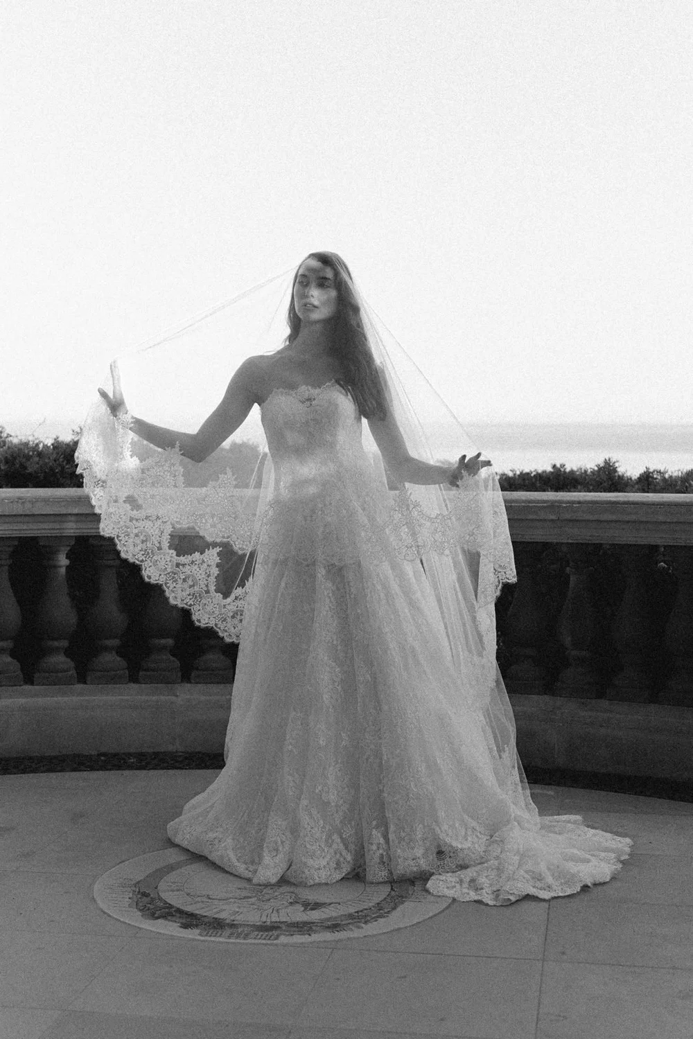 Bride with cathedral veil on a terrace above the sea at Cap Ferrat