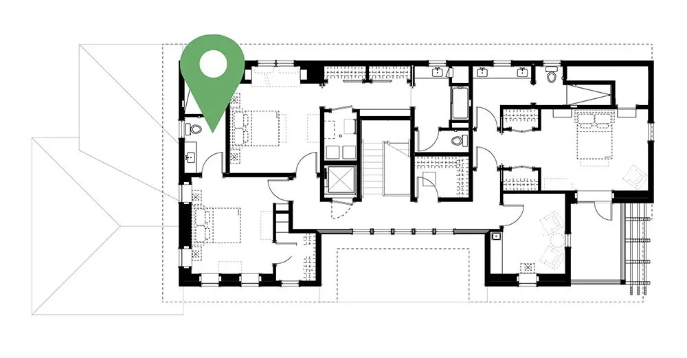 Floor plan of a house with various rooms, including bedrooms, bathrooms, and living areas. A green location marker is placed near the top left of the plan.