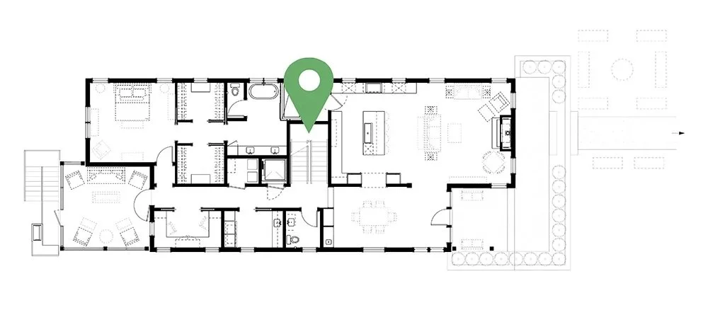 Floor plan of a house with a green location pin marking a central area