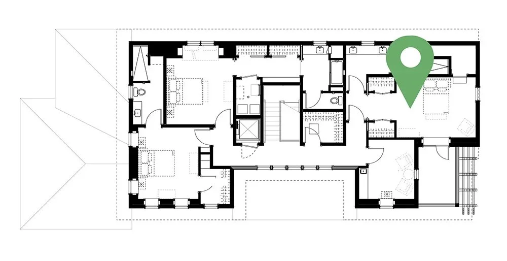 Floor plan of a house with various rooms, including bedrooms, bathrooms, and living areas, marked with a green location pin.