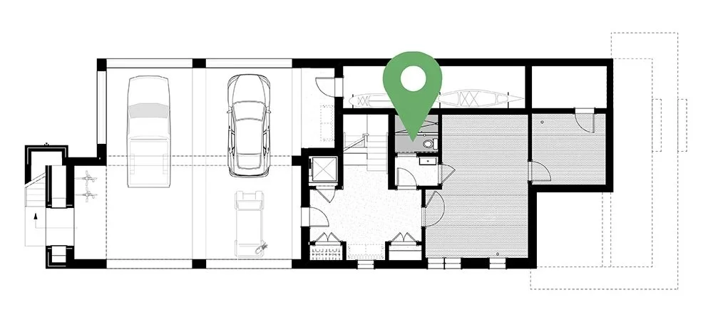 Floor plan of a house with a garage, bedrooms, and bathrooms, marked with a green location pin.