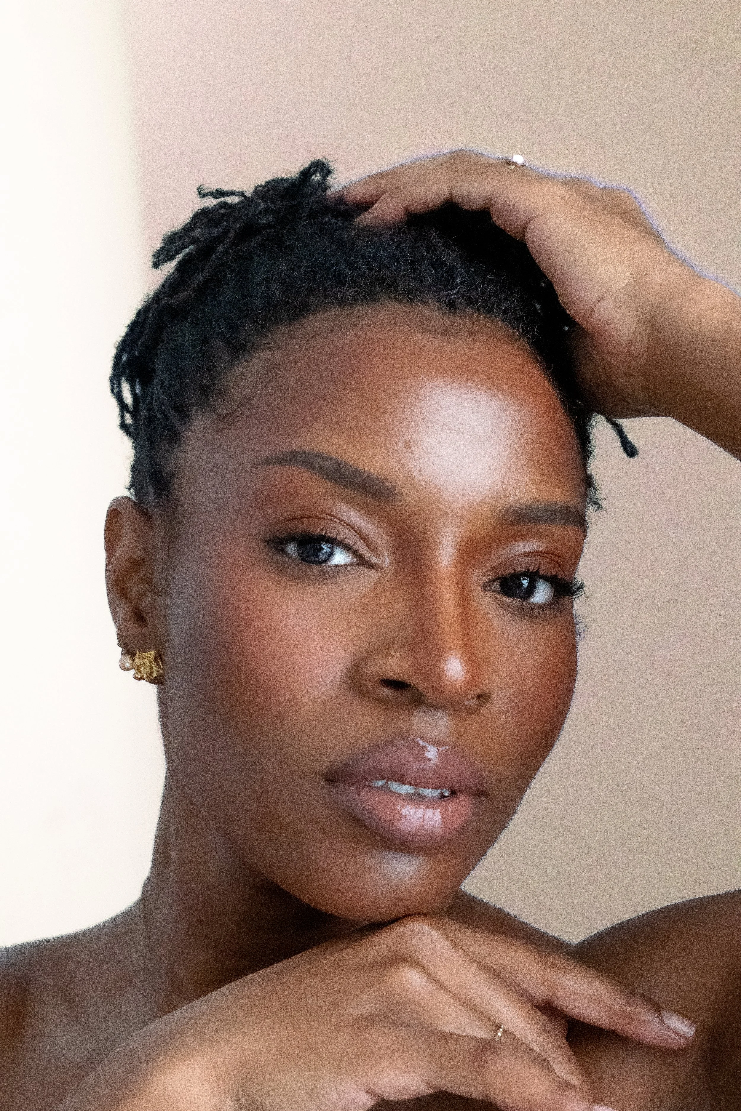 Woman with locs beauty shot peach background 3.jpg