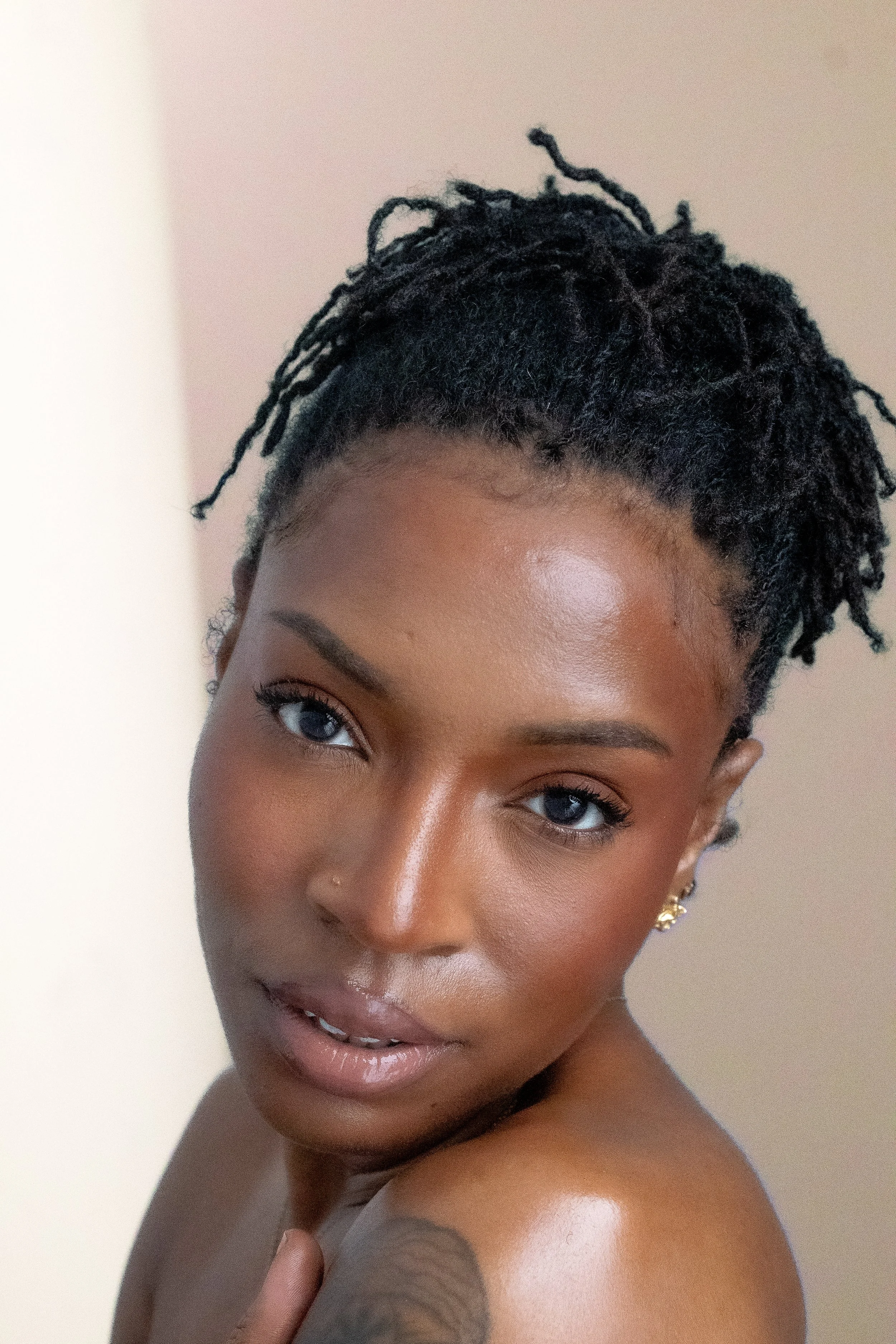 Woman with locs beauty shot peach background 4.jpg