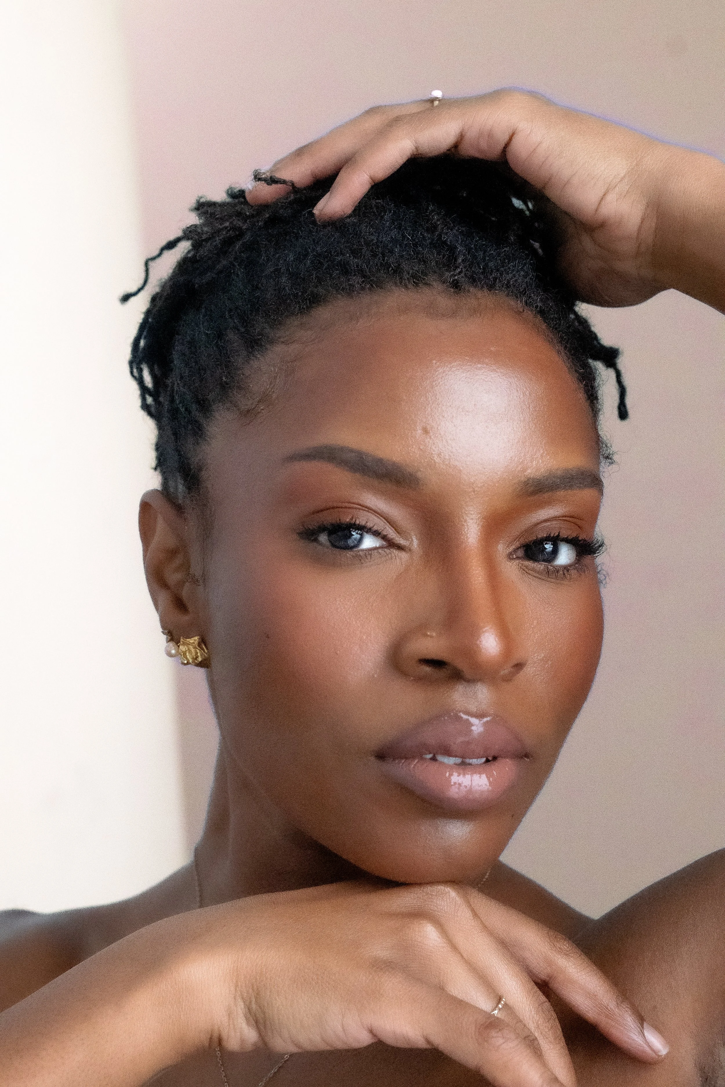 Woman with locs beauty shot peach background 2.jpg