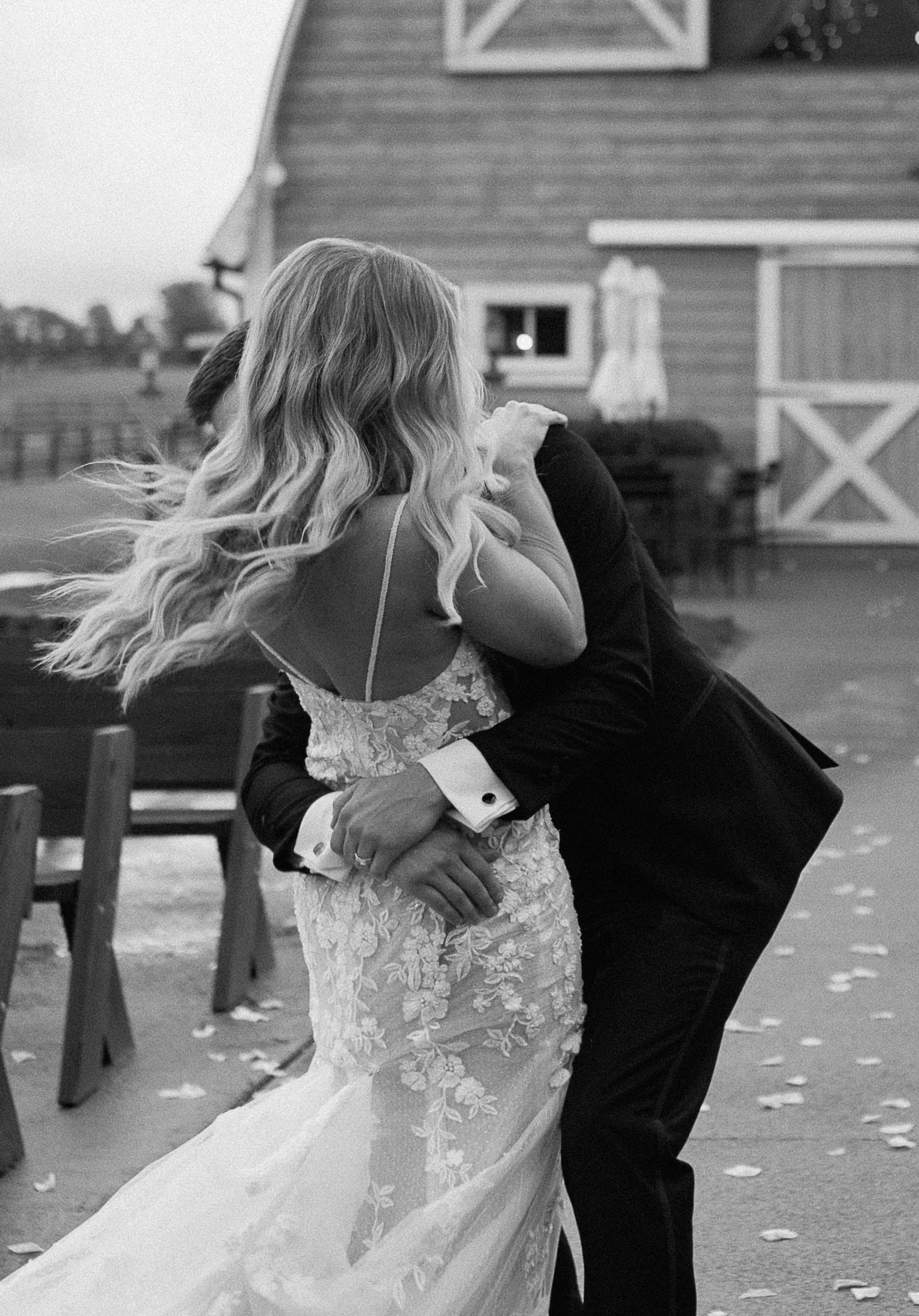 groom holding bride and dancing in front of pittsburgh wedding venue