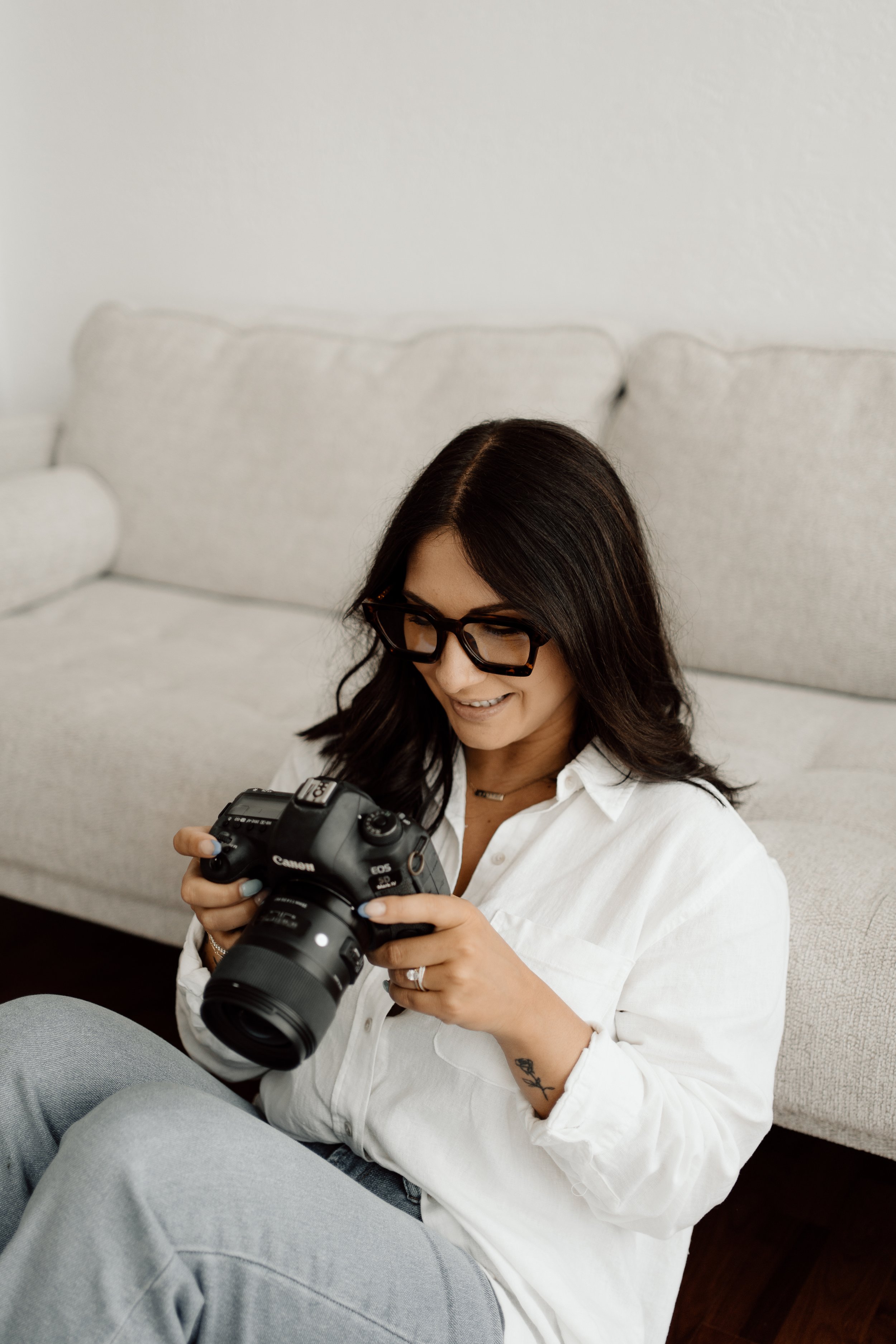 picture of photographer looking at her camera in studio