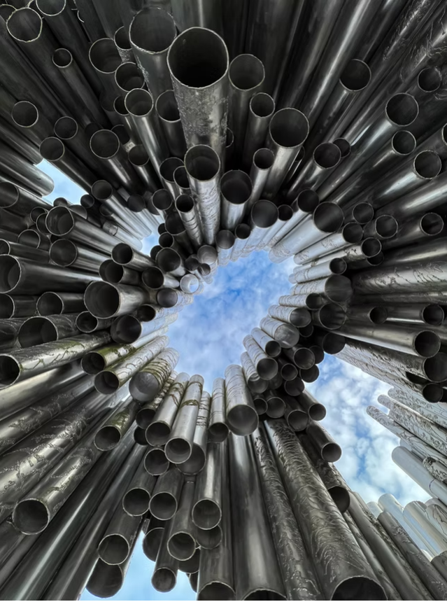 Looking upward towards the sky through pipes
