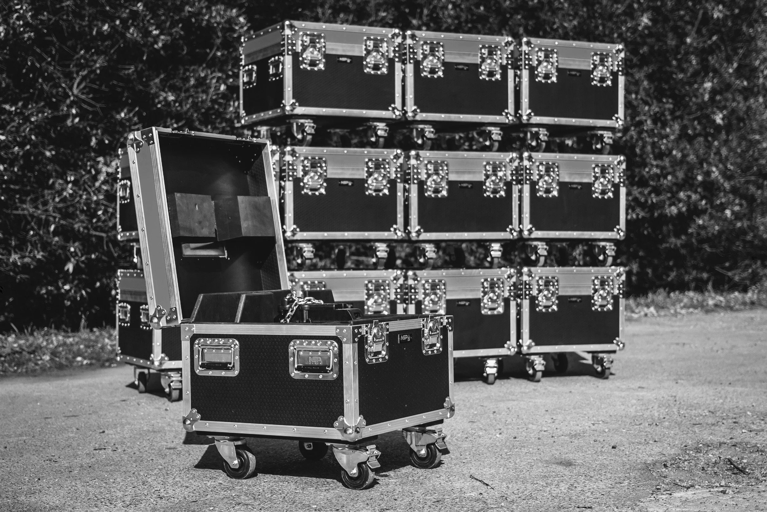 A small batch of chain hoist flight cases stacked together
