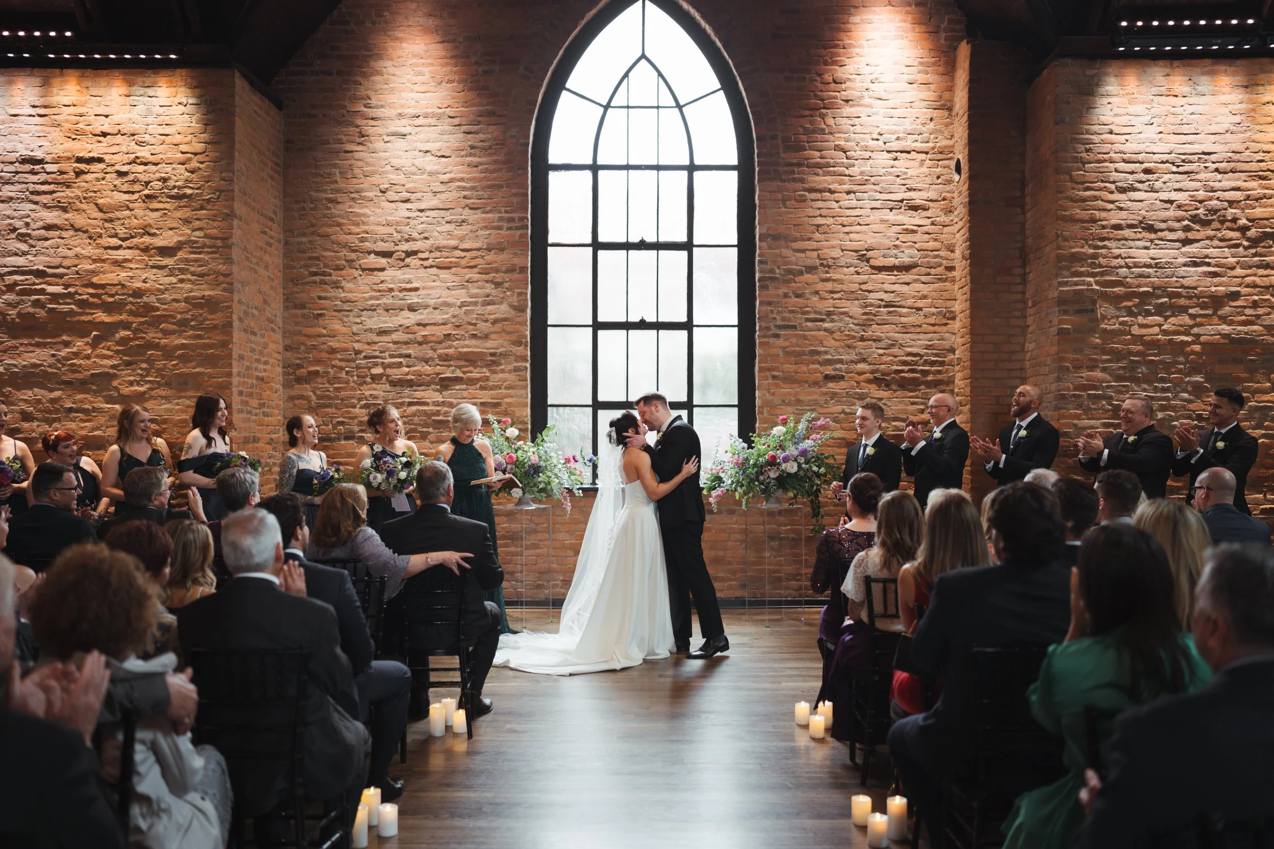 Ceremony, flower arrangements,  bride and groom kissing