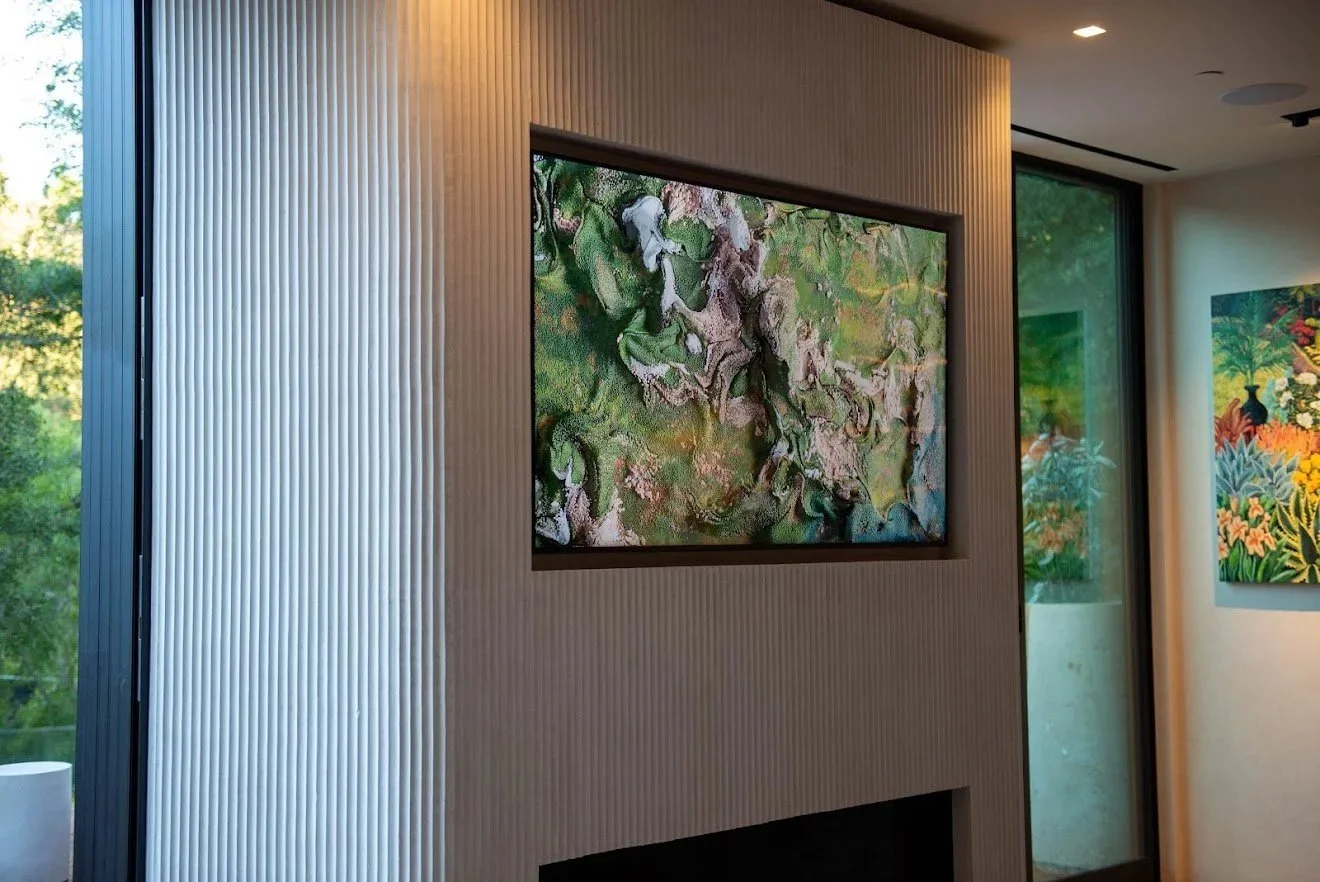 Green abstract painting on a fluted wall beside a window