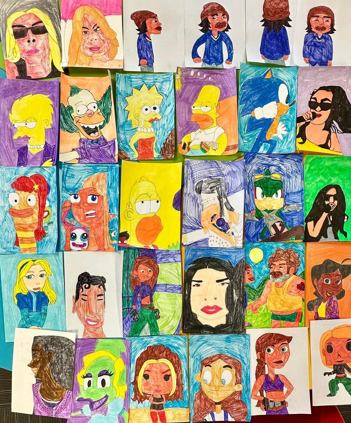 Some of the many interests of Sophi Sol.
All work by Sophi Sol, felt pen on paper.
Image description: a series of hand drawn portraits including cartoon characters and celebrities.