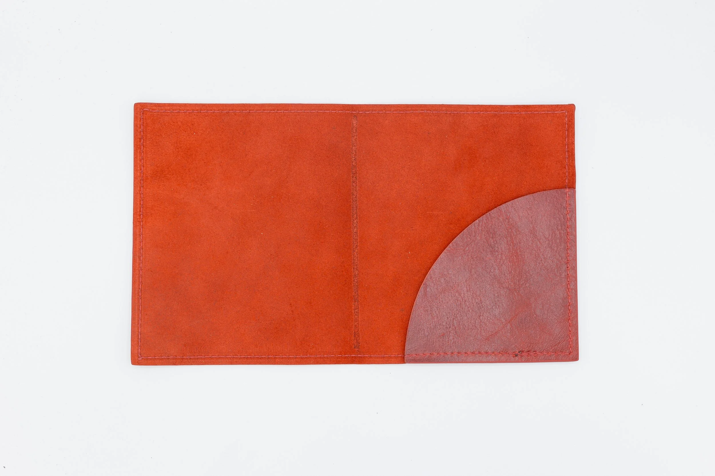 Orange leather check presenter with a curved corner pocket, isolated on a white background.